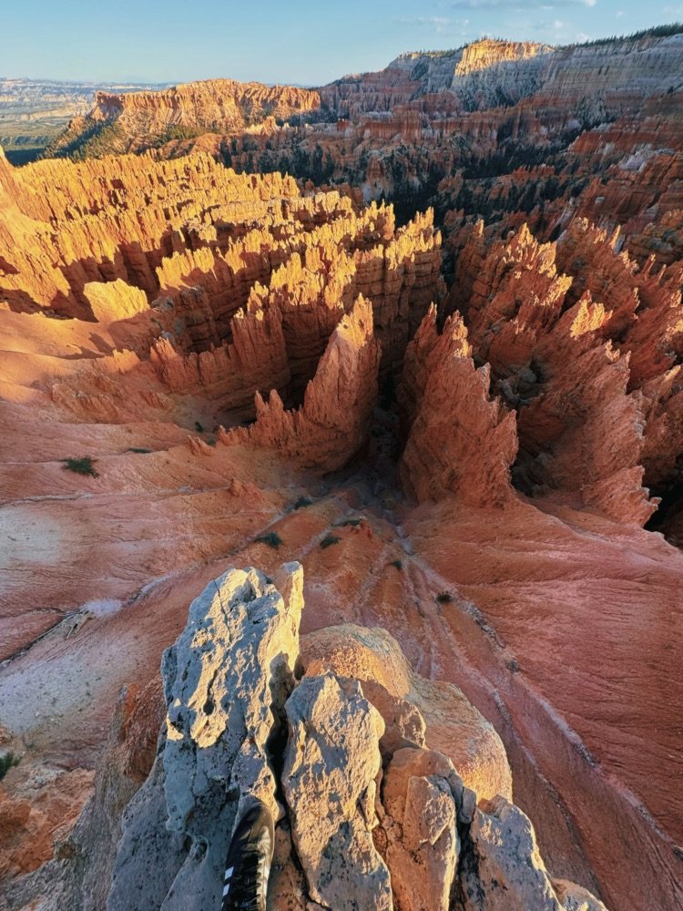 Sunrise lighting the hoodoo rock spires of Bryce Canyon from the rim.